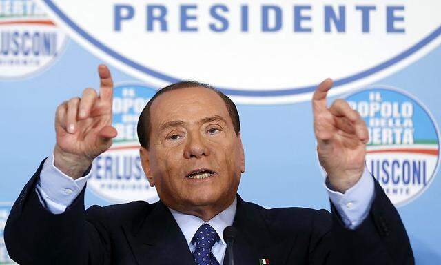 Former Italian Prime Minister Silvio Berlusconi gestures during a news conference at the headquarter of PDL in Rome