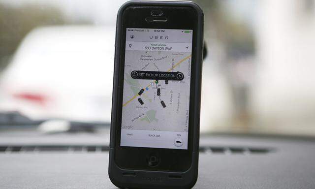 Transportation app Uber is seen on a mobile phone in a limousine in Beverly Hills