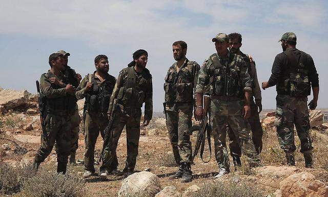 Syrian army soldiers loyal to President Bashar al-Assad walk at Hagop's Castle and Hill