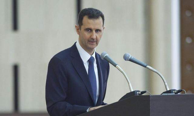 Syria's President Assad delivers a speech while attending an Iftar session in Damascus