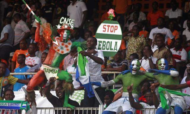 Spectators hold up a sign during the 2015 African Nations Cup qualifying soccer match between Ivory Coast and Sierra Leone in Abidjan