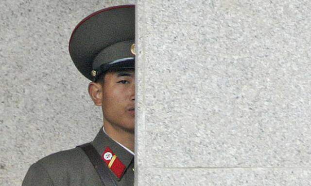 A North Korean Army soldier watches the South Korean side