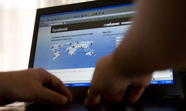 FILE - In this July 16, 2009 file photo, a Facebook user logs into their account in Ottawa, Ontario, 