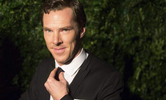 British actor Cumberbatch adjusts his tie at the Evening Standard Theatre awards in London
