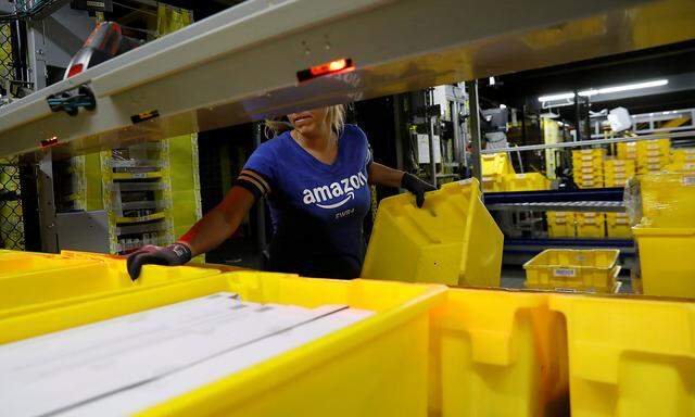 An Amazon employee works in the picking station for merchandise at the Amazon fulfillment center in Robbinsville