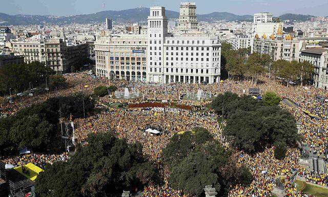 Catalan pro-independence demonstrators gather at Catalunya square during a rally in Barcelona