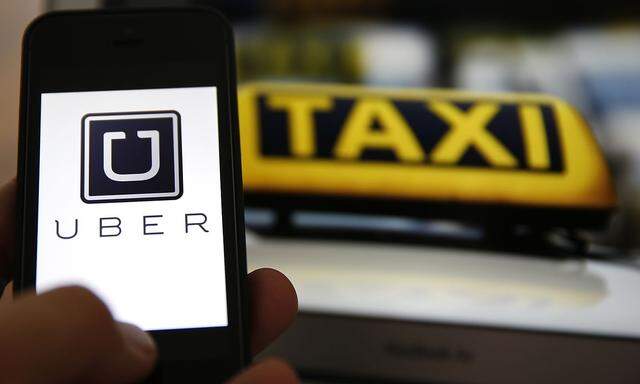 File illustration picture showing the logo of car-sharing service app Uber on a smartphone next to the picture of an official German taxi sign