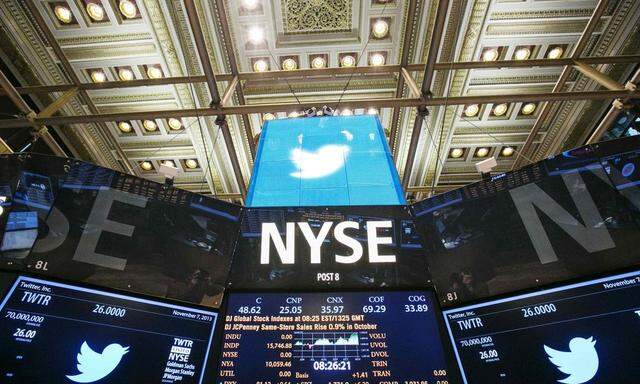 The Twitter Inc. logo is displayed on screens prior to its IPO on the floor of the New York Stock Exchange in New York