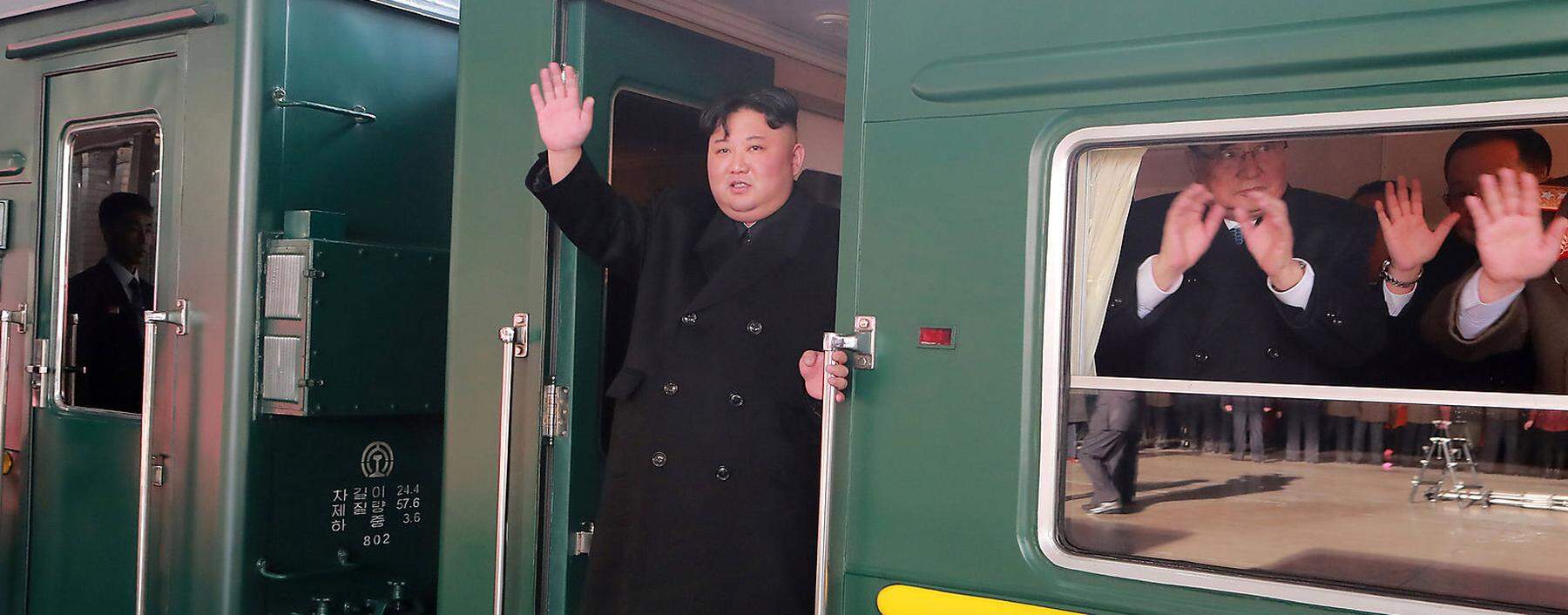 North Korean leader Kim Jong Un waves from a train as he departs for a summit in Hanoi