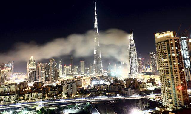 The Address Downtown Dubai hotel and residential block is seen engulfed by fire near the Burj Khalifa, the tallest building in the world, during the New Year celebrations in Dubai