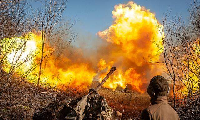 Ukrainian servicemen fire a 130 mm towed field gun M-46 on a front line near Soledar