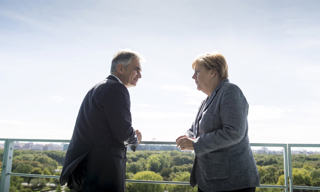 German Chancellor Merkel talks to Austrian Chancellor Faymann at the chancellery in Berlin