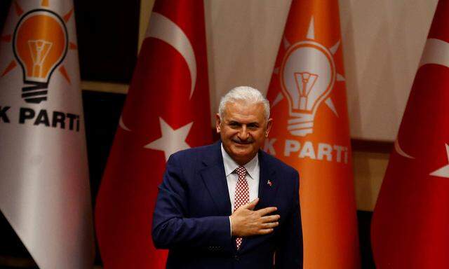 Turkey´s likely next prime minister and incoming leader of the ruling AK Party Binali Yildirim greets party members during a meeting in Ankara