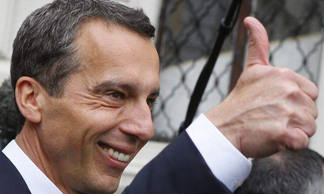 Austrian new Chancellor Kern gives a thumb up as he leaves after the swearing in ceremony in the presidential office in Vienna