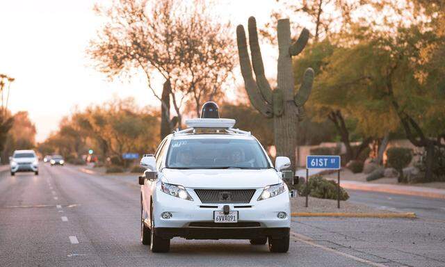 Test drivers use a Lexus SUV, built as a self-driving car, to map the area prior to a journey without a driver in control, in Phoenix
