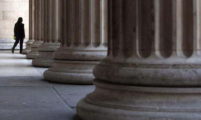 A man walks through columns outside the British Museum in London