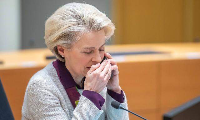 BRUSSELS - President of the European Council Ursula Von Der Leyen uses her mobile phone before the roundtable meeting on