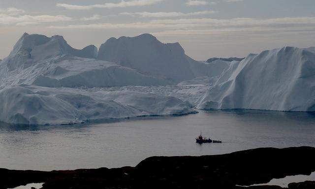 FILE PHOTO: A fishing vessel sails in the ice fjord near Ilulissat