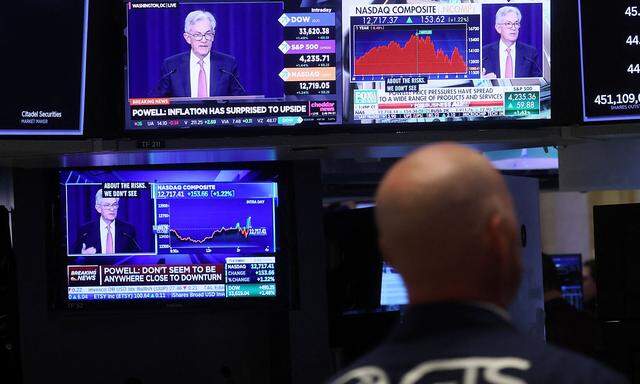 Traders work on the floor of the NYSE in New York