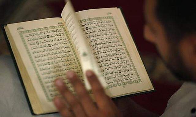 A Muslim man reads the Koran on the first day of Ramadan at a mosque in the southern Spanish town of 
