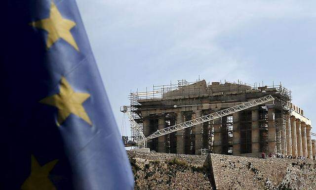 An EU flag flutters as the ancient Parthenon temple is seen in the background in Athens 