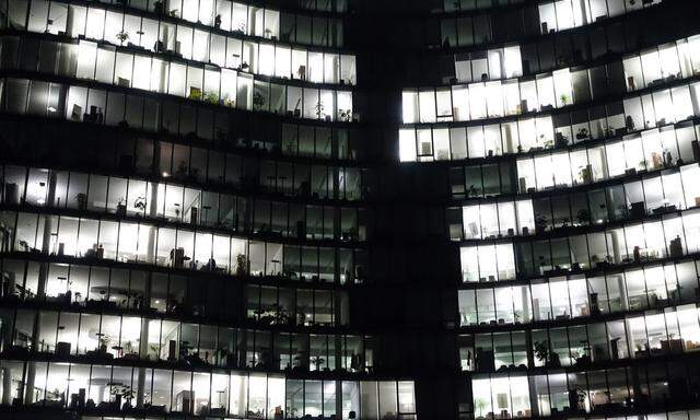 Austria, Vienna, lighted windows of an office building by night