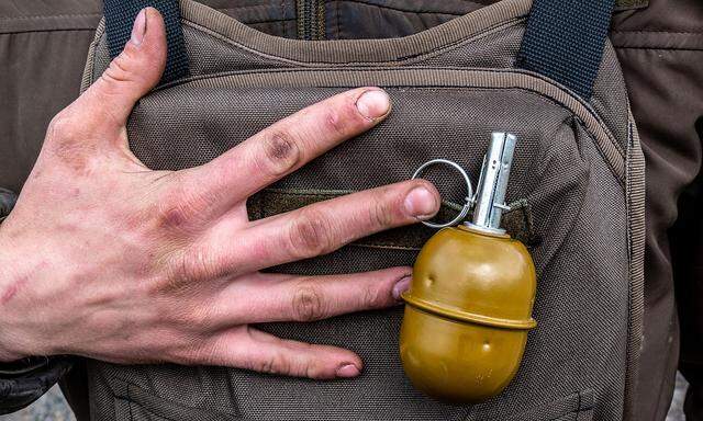 Grenade is pictured attached on a vest of a soldier