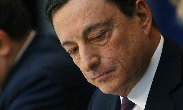 European Central Bank (ECB) President Draghi reads a paper during the monthly ECB news conference in Frankfurt