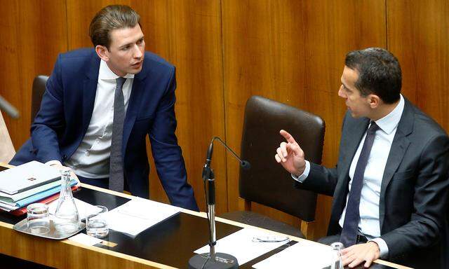 FILE PHOTO: Austria's Foreign Minister Kurz and Chancellor Kern talk in Vienna
