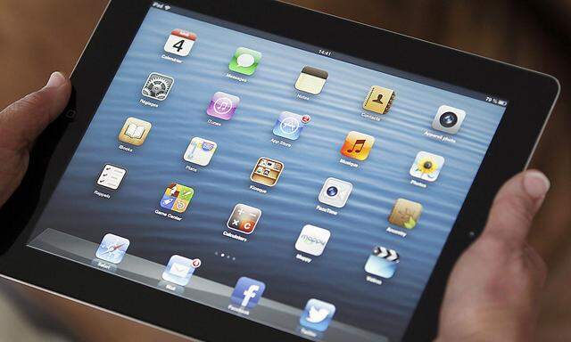 An illustration picture show sapplication icons are displayed on an Apple Ipad tablet held by a woman  in Bordeaux