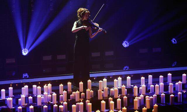 U.S. musician Stirling performs as candles are light to commemorate the victims of the Germanwings plane crash at the beginning of the Echo Music Awards ceremony in Berlin
