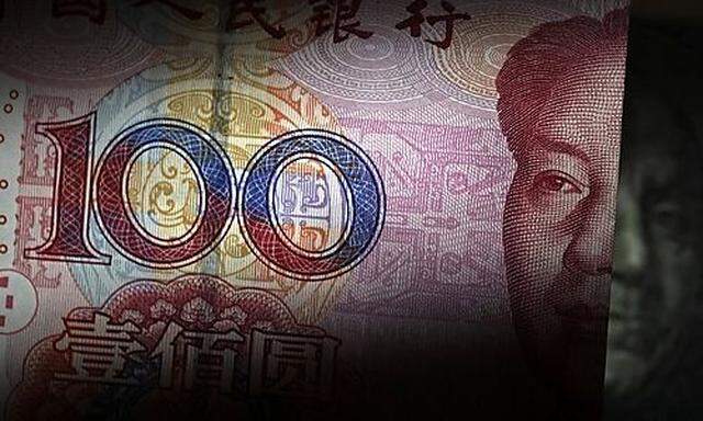 A 100 yuan banknote is placed next to a U.S. 100 dollar banknote in this picture illustration