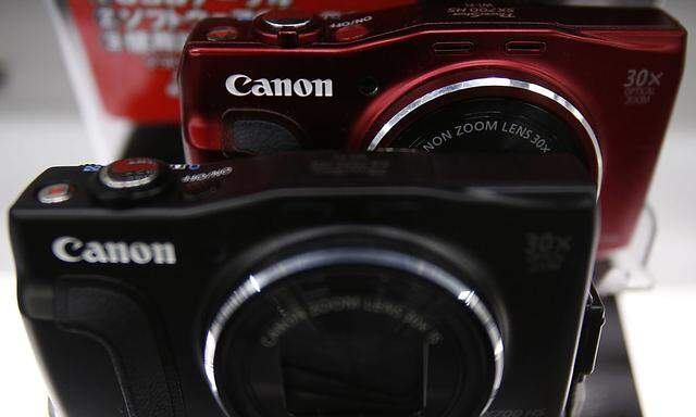 Canon´s logos are seen on compact digital camera on display at an electronics retail store in Tokyo