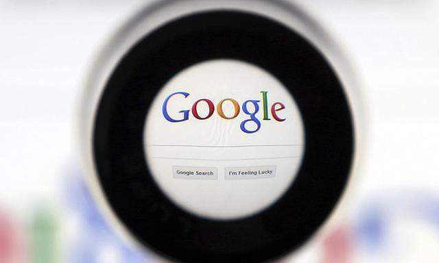 A Google search page is seen through a magnifying glass in this photo illustration taken in Brussels
