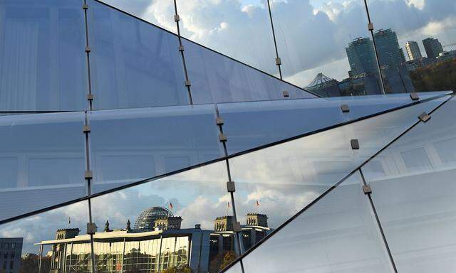 The German lower house of parliament Bundestag is pictured in a reflection in Berlin