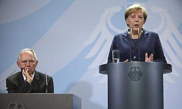 German Chancellor Merkel and Finance Minister Schaeuble attend news conference after talks with finan