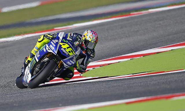 Yamaha MotoGP rider Rossi of Italy takes a curve during the third practice session of the San Marino Grand Prix in Misano Adriatico circuit in central Italy