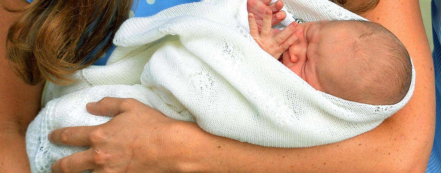 Britain's Prince William and his wife Catherine, Duchess of Cambridge appear with their baby son outside the Lindo Wing of St Mary's Hospital, in central London