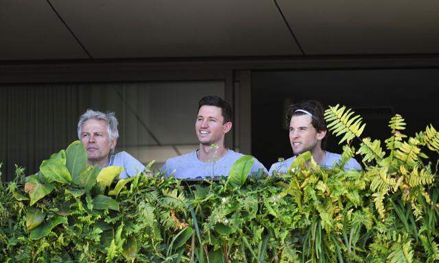 Support Staff and tennis player Dominic Thiem are seen on a balcony during quarantine in Adelaide