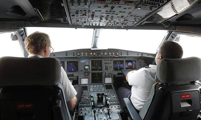 Pilots sit at the cockpit of a VietJet  A320 airplane before departure for Bangkok in this file photo