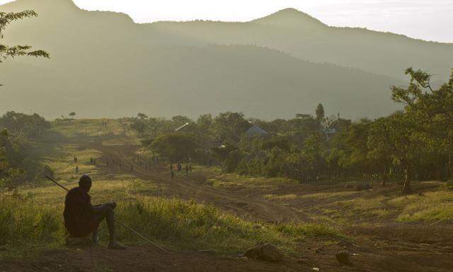 Africa Ethiopia Omo region Kibish Tribesman sitting near trail leading to Suri village PUBLICAT