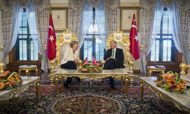 Handout shows Turkish President Erdogan listening to German Chancellor Merkel during their meeting in Istanbul