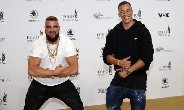 German rappers Kollegah and Farid Bang pose during a photocall upon arrival for the 2018 Echo Music Award ceremony in Berlin