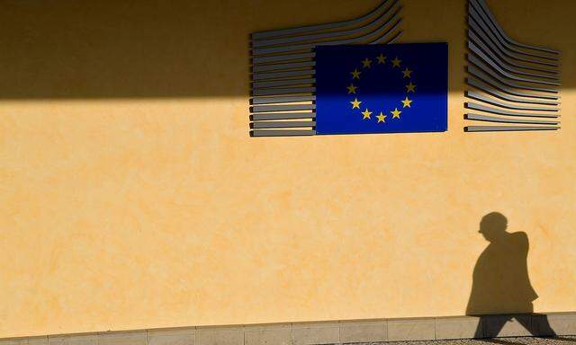 FILE PHOTO: The shadow of a worker is seen beside the EU Commission building in Brussels, Belgium