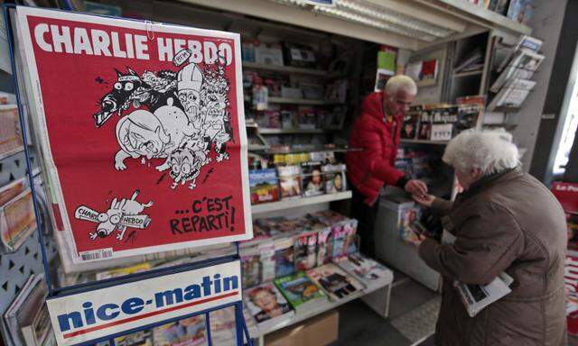 The front page of the new issue of satirical French weekly Charlie Hebdo entitled is displayed at a kiosk in Nice