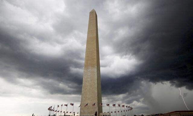 Storm clouds hover above the Washington monument in Washington DC