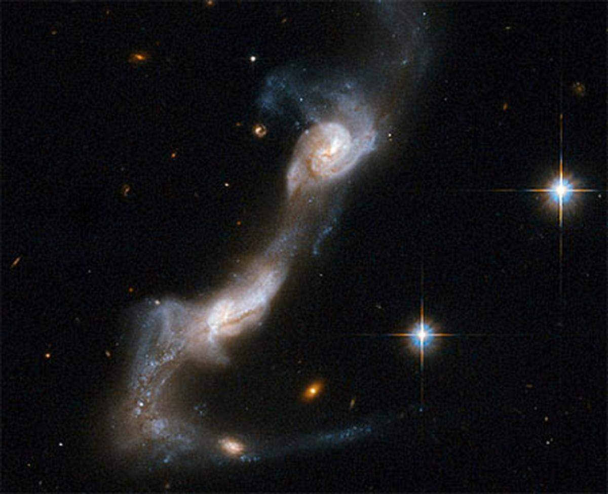 Diese Spiral-Galaxien sind bereits durch ein Band aus Gas und Staub miteinander verbunden - bald werden sie vollständig zusammenwachsen.