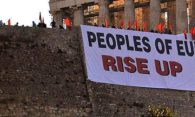 Greek protesters unfurl banners over the defensive walls of the ancient Acropolis, the countrys mosts most