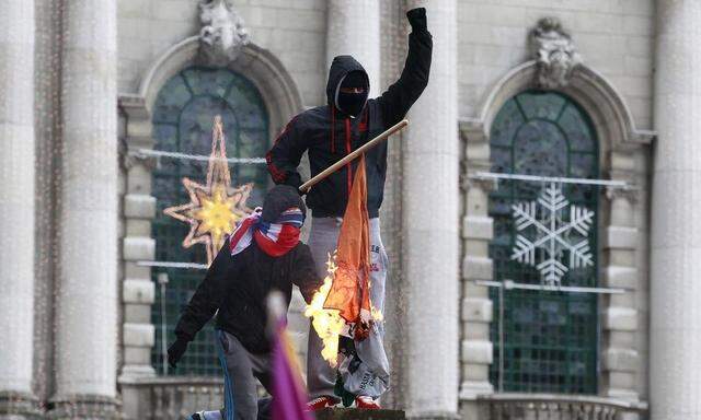 Protestors burn the Irish national flag in front of Belfast's City Hall