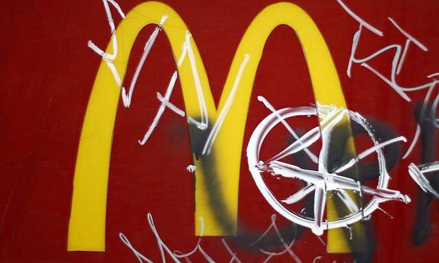 A McDonald's logo is seen covered in graffiti at a restaurant in Los Angeles